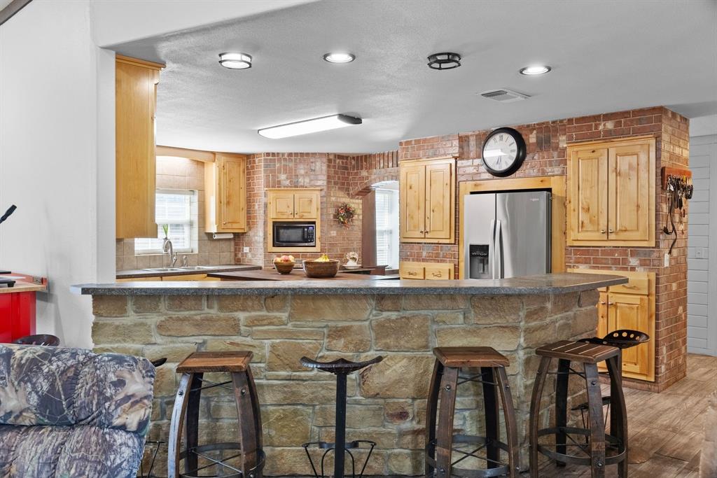 24 County Rd NW 1060 Talco, TX 75487 - Photo 12 of 40 a view of a kitchen with a window and dining table
