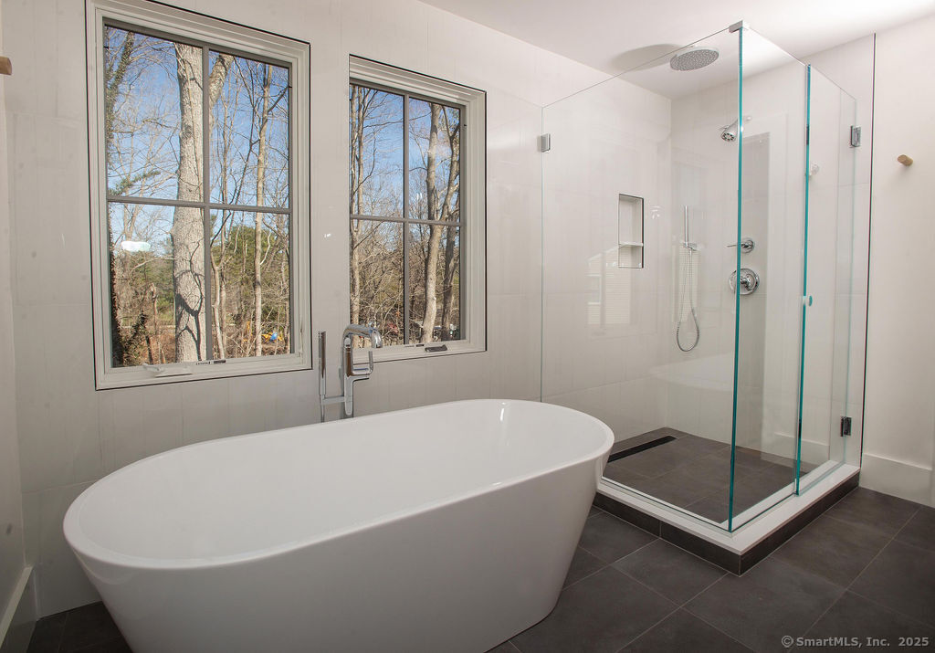 6 Down River Road, Unit B New Canaan, CT 06840 - Photo 14 of 31 a white bath tub sitting next to a window