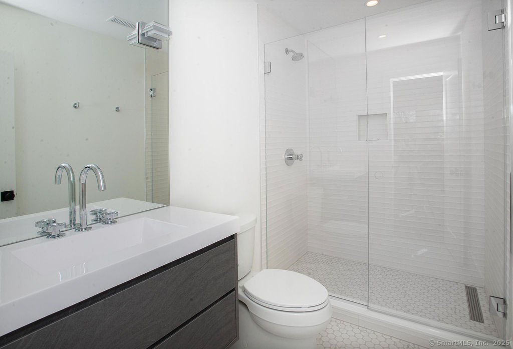 6 Down River Road, Unit B New Canaan, CT 06840 - Photo 18 of 31 a bathroom with a sink a toilet and shower
