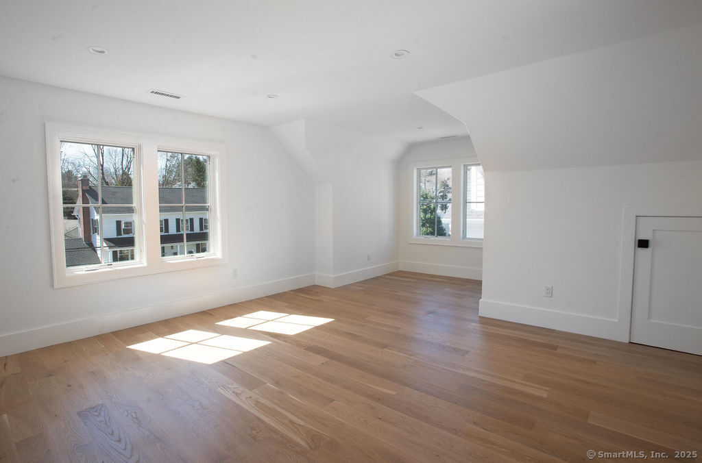 6 Down River Road, Unit B New Canaan, CT 06840 - Photo 24 of 31 a view of an empty room with wooden floor and a window