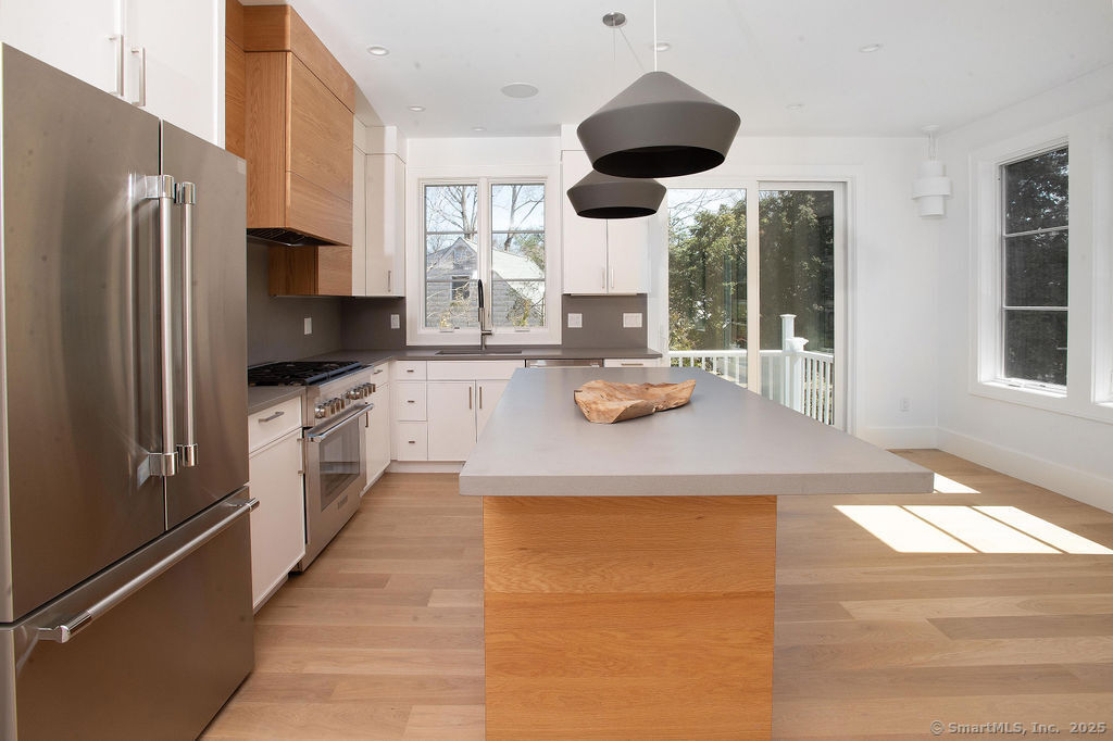 6 Down River Road, Unit B New Canaan, CT 06840 - Photo 3 of 31 a kitchen with stainless steel appliances a large counter top space cabinets and a large window