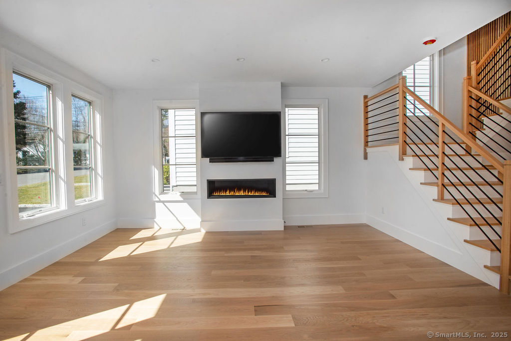 6 Down River Road, Unit B New Canaan, CT 06840 - Photo 8 of 31 a living room with furniture and a flat screen tv