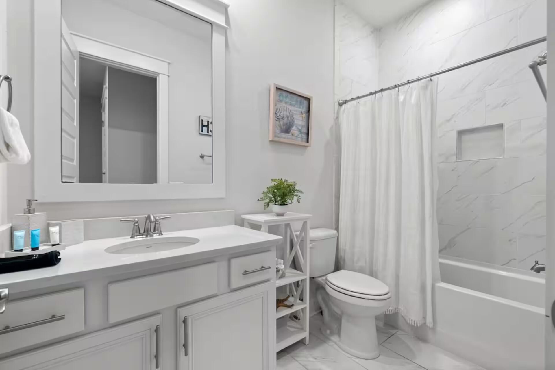 146 East E Pine, Unit B Inlet Beach, FL 32461 - Photo 26 of 47 a bathroom with a sink a toilet and shower curtain