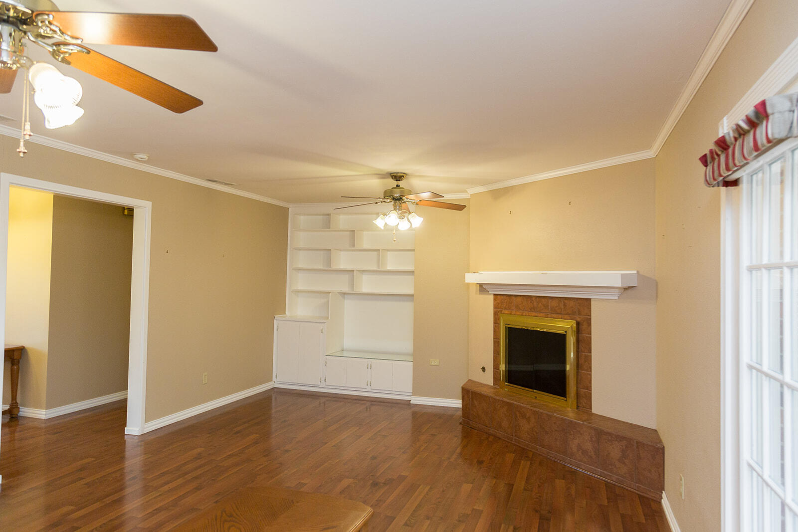 1209 Dallas Plainview, TX 79072 - Photo 11 of 57 a view of empty room with wooden floor and fan