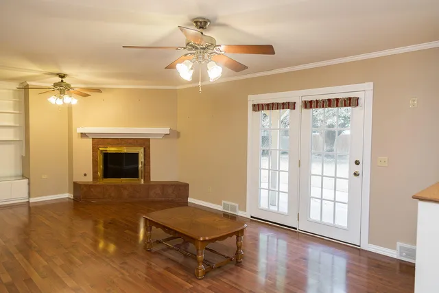 a view of a livingroom with a ceiling fan and window