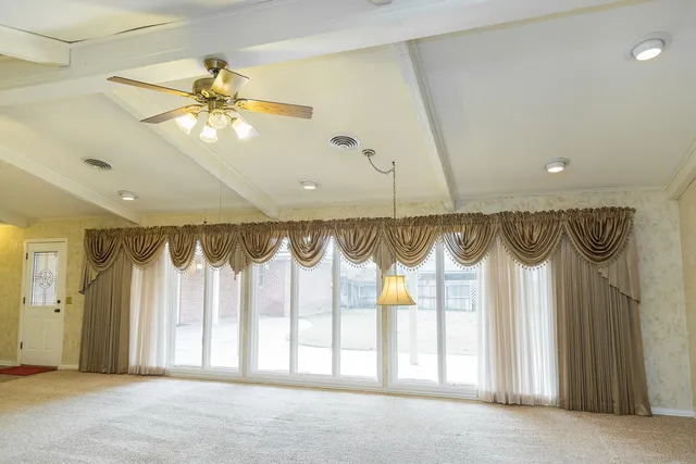 a backyard of a house with table and chairs