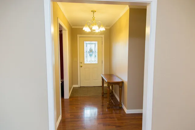 a view of a livingroom with wooden floor and a ceiling fan