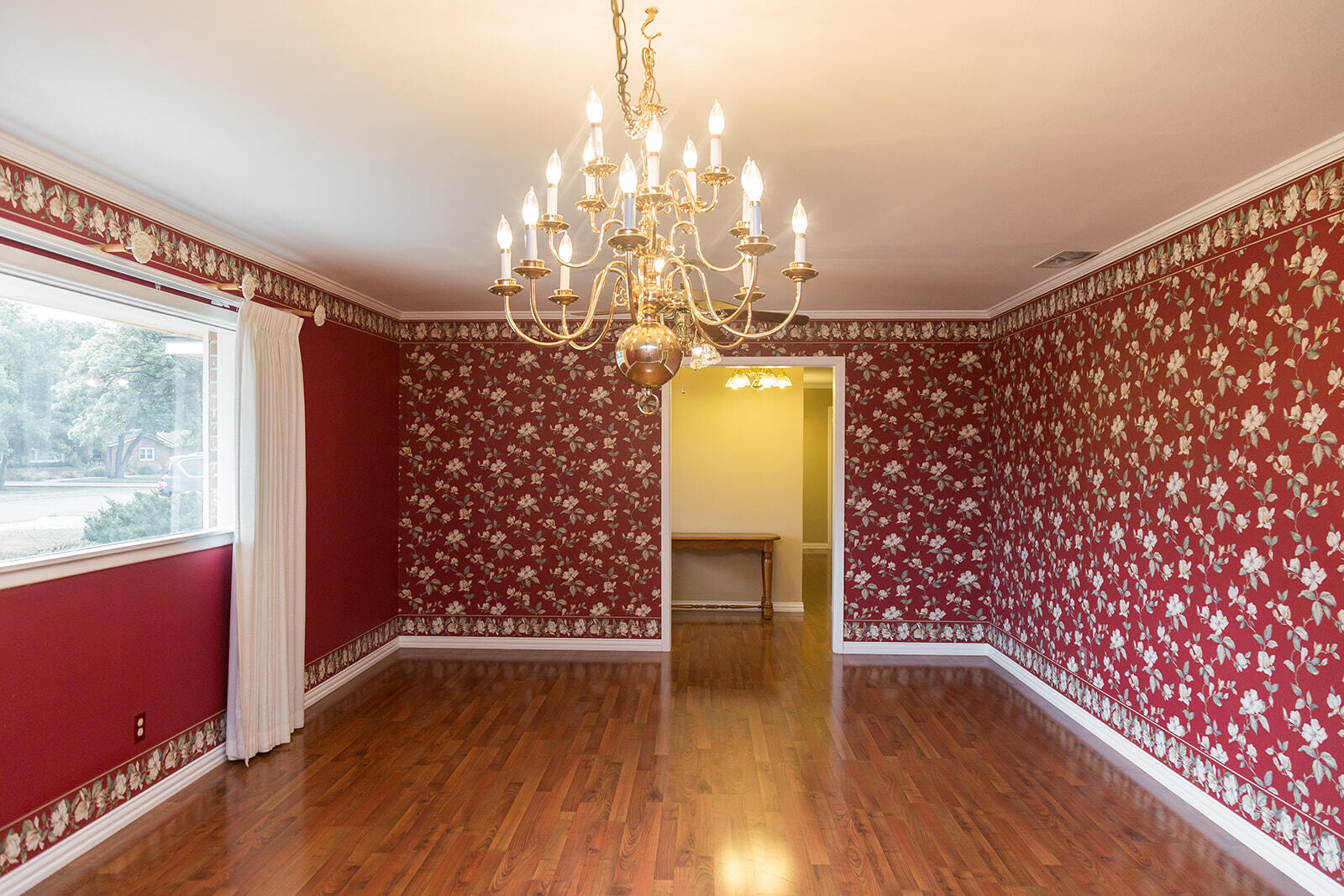 1209 Dallas Plainview, TX 79072 - Photo 8 of 57 a view of livingroom with window and wooden floor