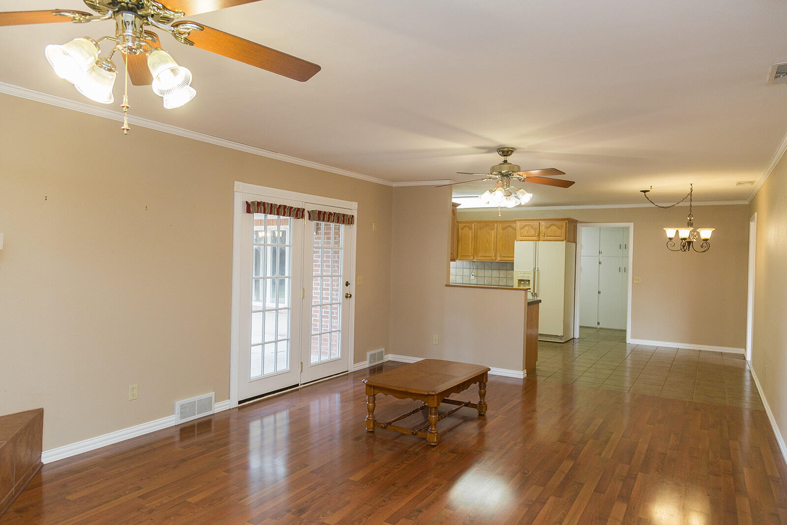 1209 Dallas Plainview, TX 79072 - Photo 9 of 57 a view of a livingroom with wooden floor and a ceiling fan