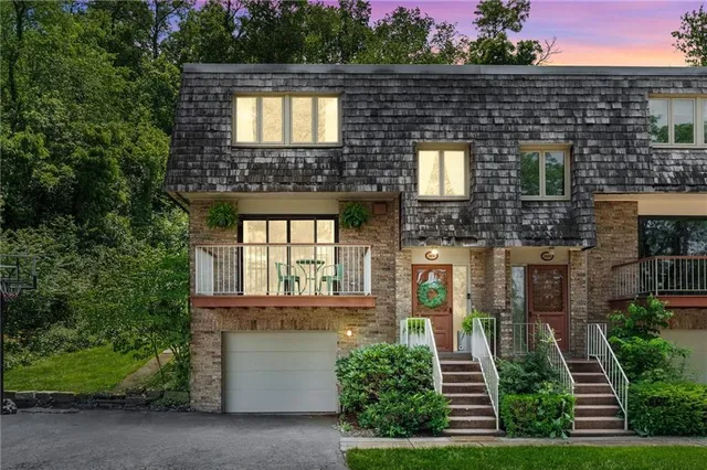 front view of a brick house with a small yard