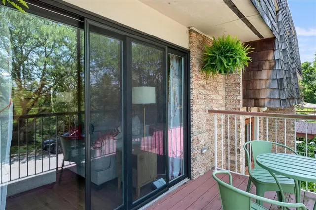 a balcony with table and chairs