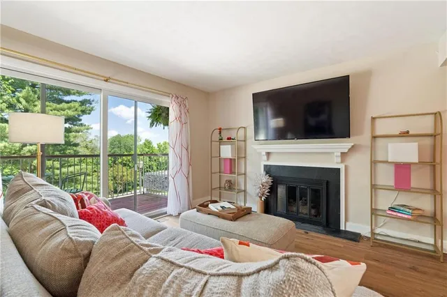 a living room with furniture a fireplace and a flat screen tv