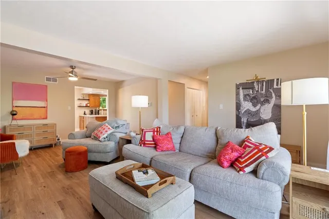a living room with furniture and wooden floor