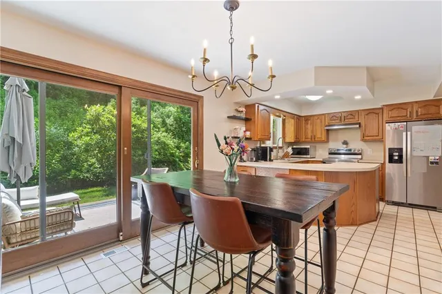 a view of a dining room with furniture large windows and wooden floor