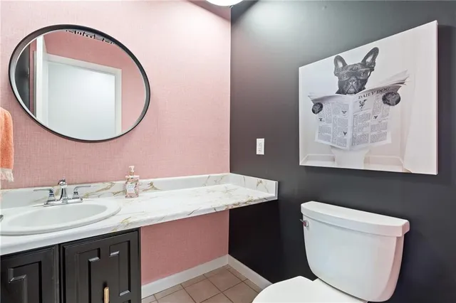 a bathroom with a toilet a sink and a mirror