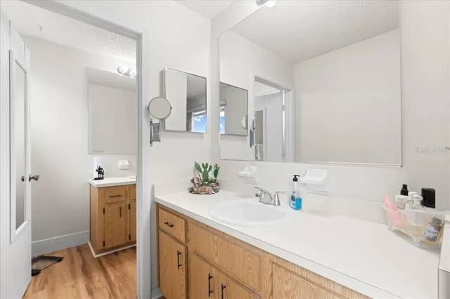 a en suite bathroom with a double vanity sink and a mirror