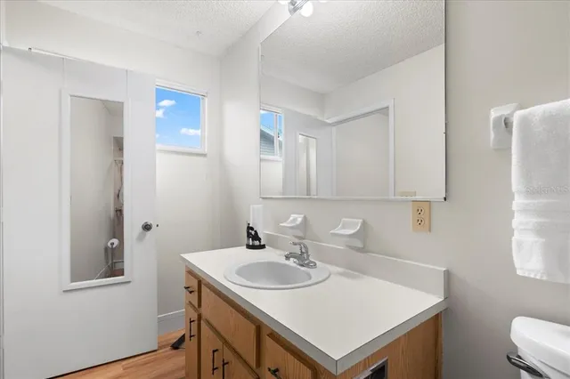 a kitchen with a sink cabinets stainless steel appliances and a window