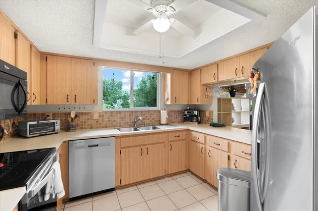 a kitchen with a sink stove and microwave