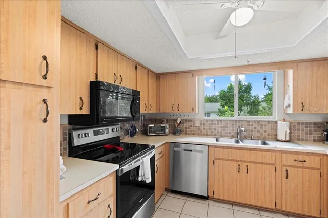 a kitchen with stainless steel appliances a refrigerator and cabinets