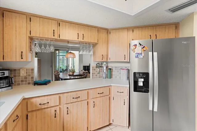 a kitchen with stainless steel appliances a stove a refrigerator and cabinets