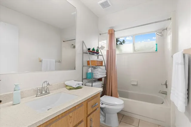 a bathroom with a sink vanity and a mirror