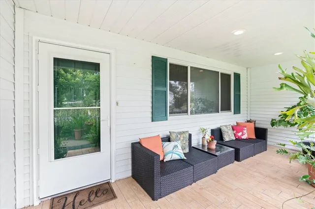 a living room with furniture and flowers