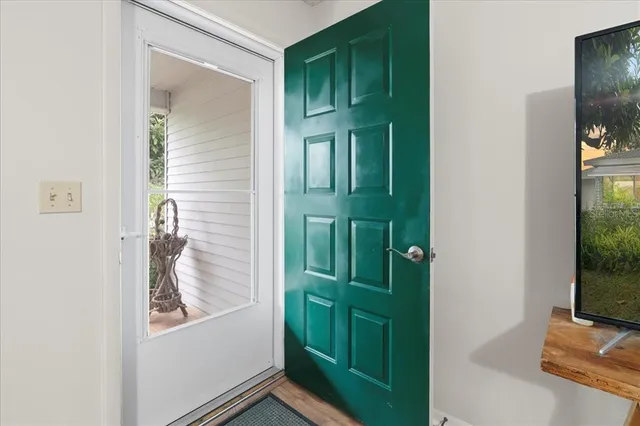 a living room with furniture and kitchen view