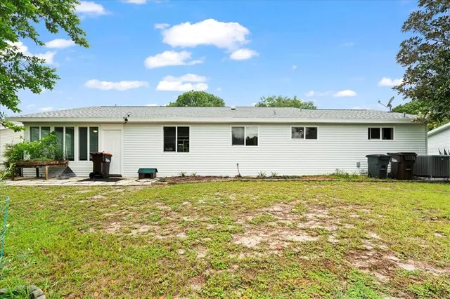 a view of a house with backyard and sitting area