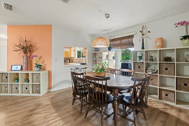 a view of a dining room with furniture and a potted plant