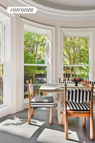 a view of a hallway with wooden floor and a living room