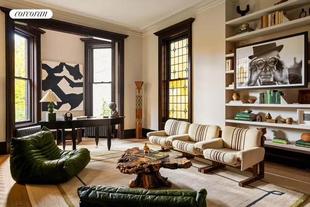 a backyard of a house with fountain table and chairs