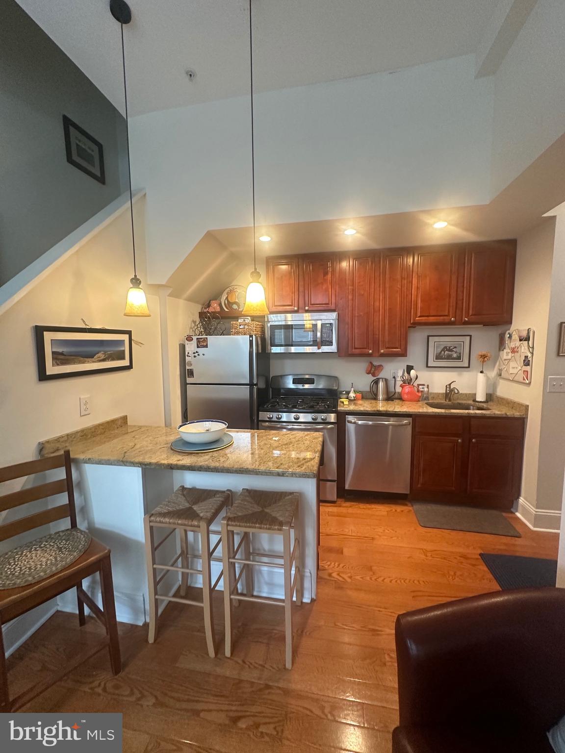 1014 Clinton Street, Unit 2R Philadelphia, PA 19107 - Photo 5 of 16 a kitchen with a table chairs refrigerator and microwave