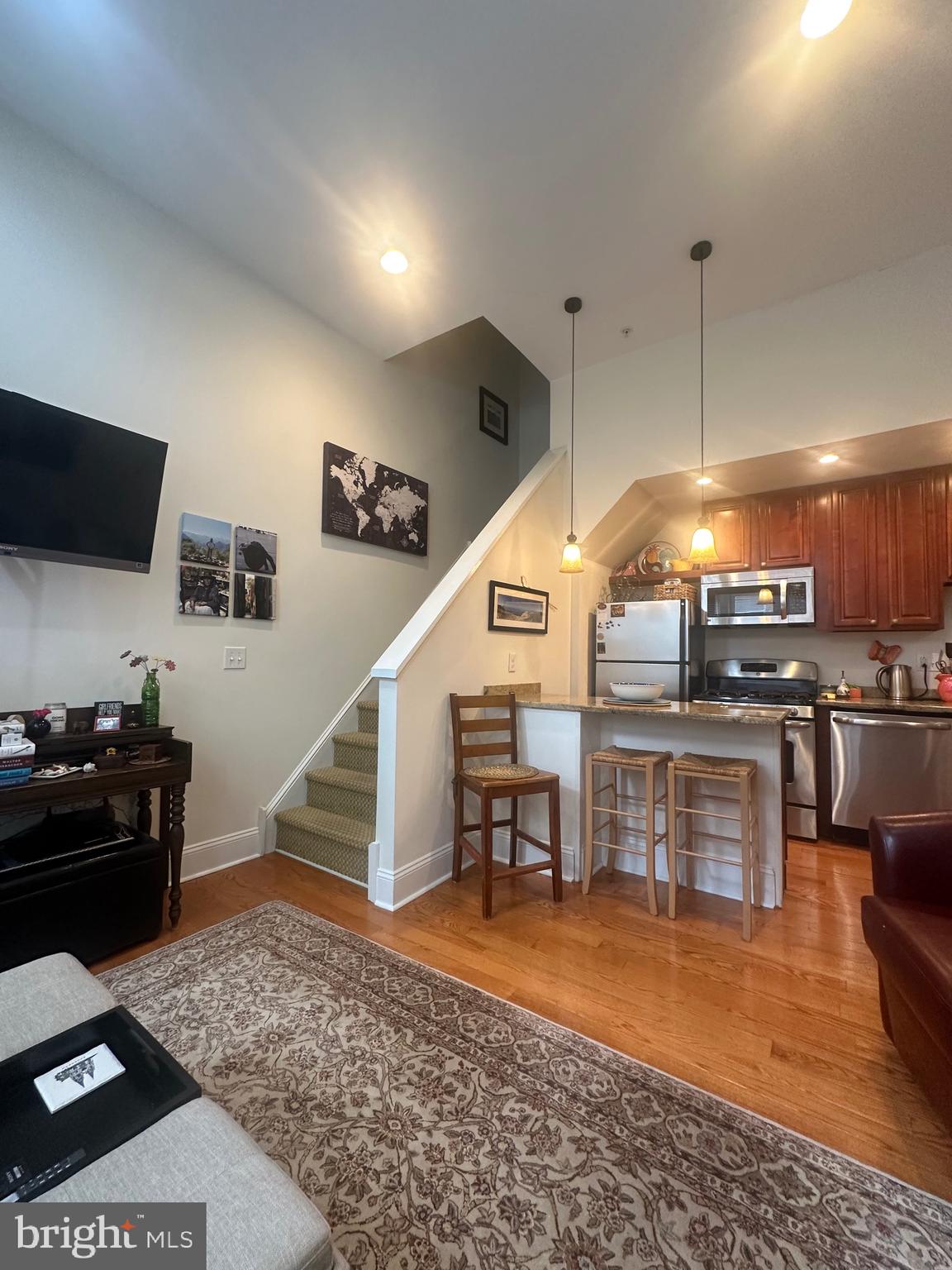 1014 Clinton Street, Unit 2R Philadelphia, PA 19107 - Photo 8 of 16 a kitchen with stainless steel appliances kitchen island granite countertop a refrigerator and a stove top oven