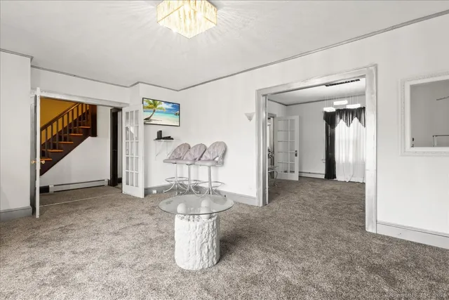 a view of staircase with wooden floor and front door