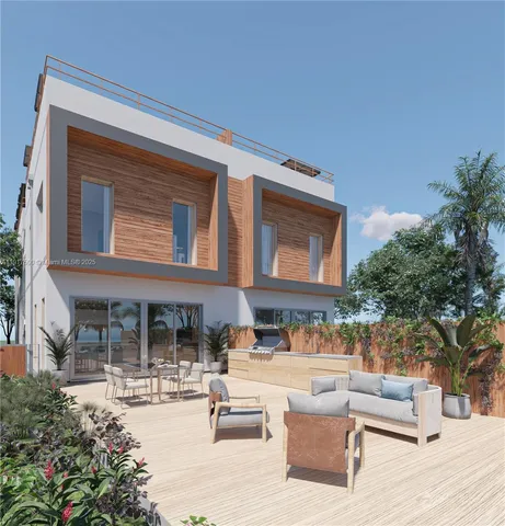 a view of a house with couches and a table and chairs