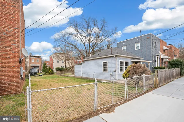 a view of a house with a yard and porch