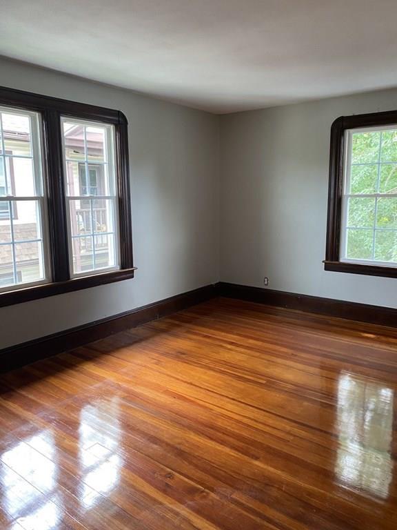 999 Sumner Avenue Springfield, MA 01118 - Photo 14 of 18 an empty room with wooden floor and windows