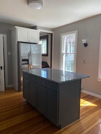 999 Sumner Avenue Springfield, MA 01118 - Photo 3 of 18 a kitchen with granite countertop a refrigerator a sink and dishwasher with wooden floor