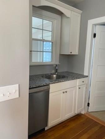 999 Sumner Avenue Springfield, MA 01118 - Photo 5 of 18 a kitchen with granite countertop white cabinets and a sink