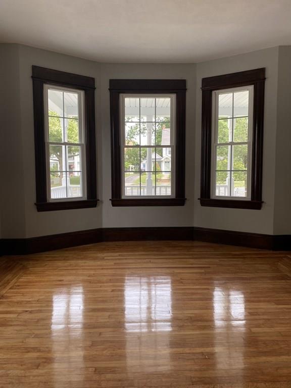 999 Sumner Avenue Springfield, MA 01118 - Photo 7 of 18 a view of an empty room with wooden floor and a window