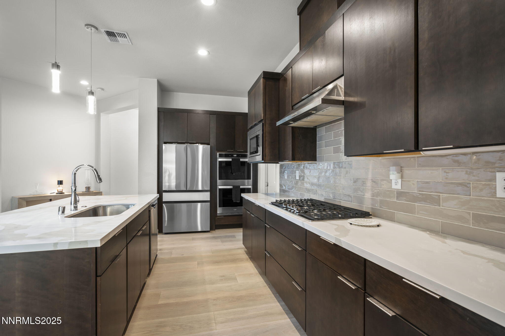 12514 Woods Clover Street Reno, NV 89521 - Photo 11 of 23 a kitchen with stainless steel appliances granite countertop a sink and stove