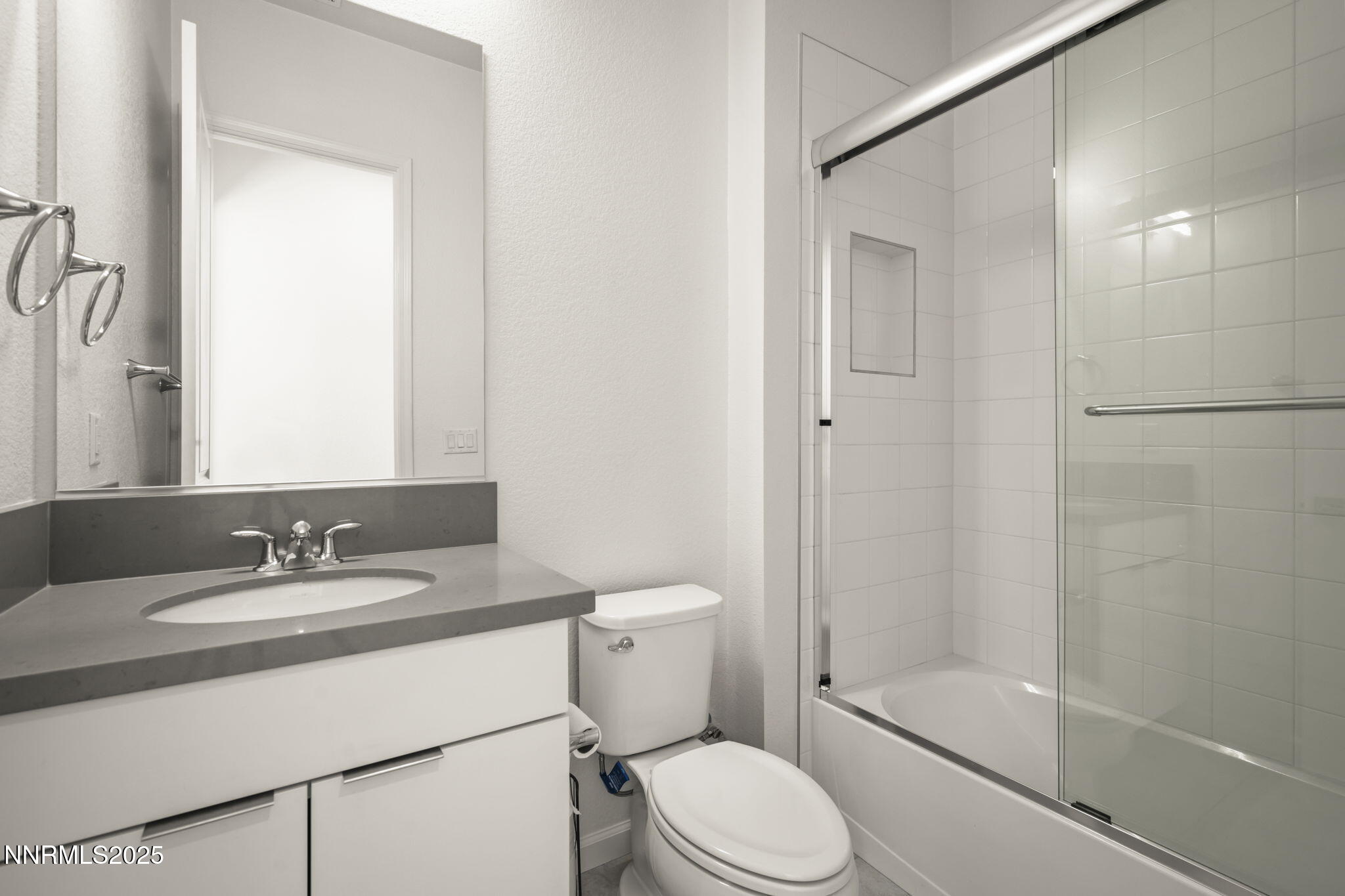 12514 Woods Clover Street Reno, NV 89521 - Photo 15 of 23 a bathroom with a sink toilet and shower