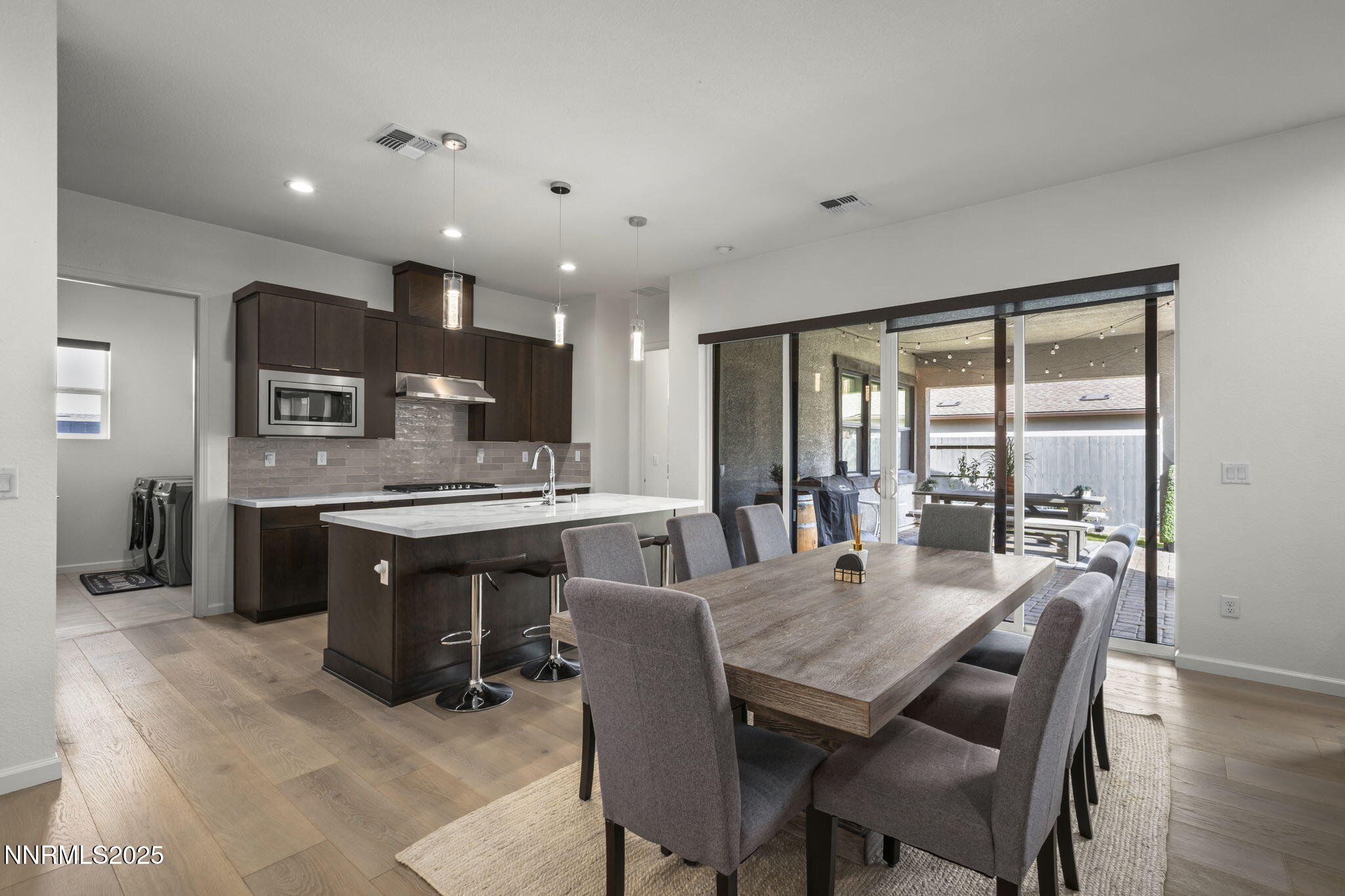 12514 Woods Clover Street Reno, NV 89521 - Photo 2 of 23 a large kitchen with a table and chairs