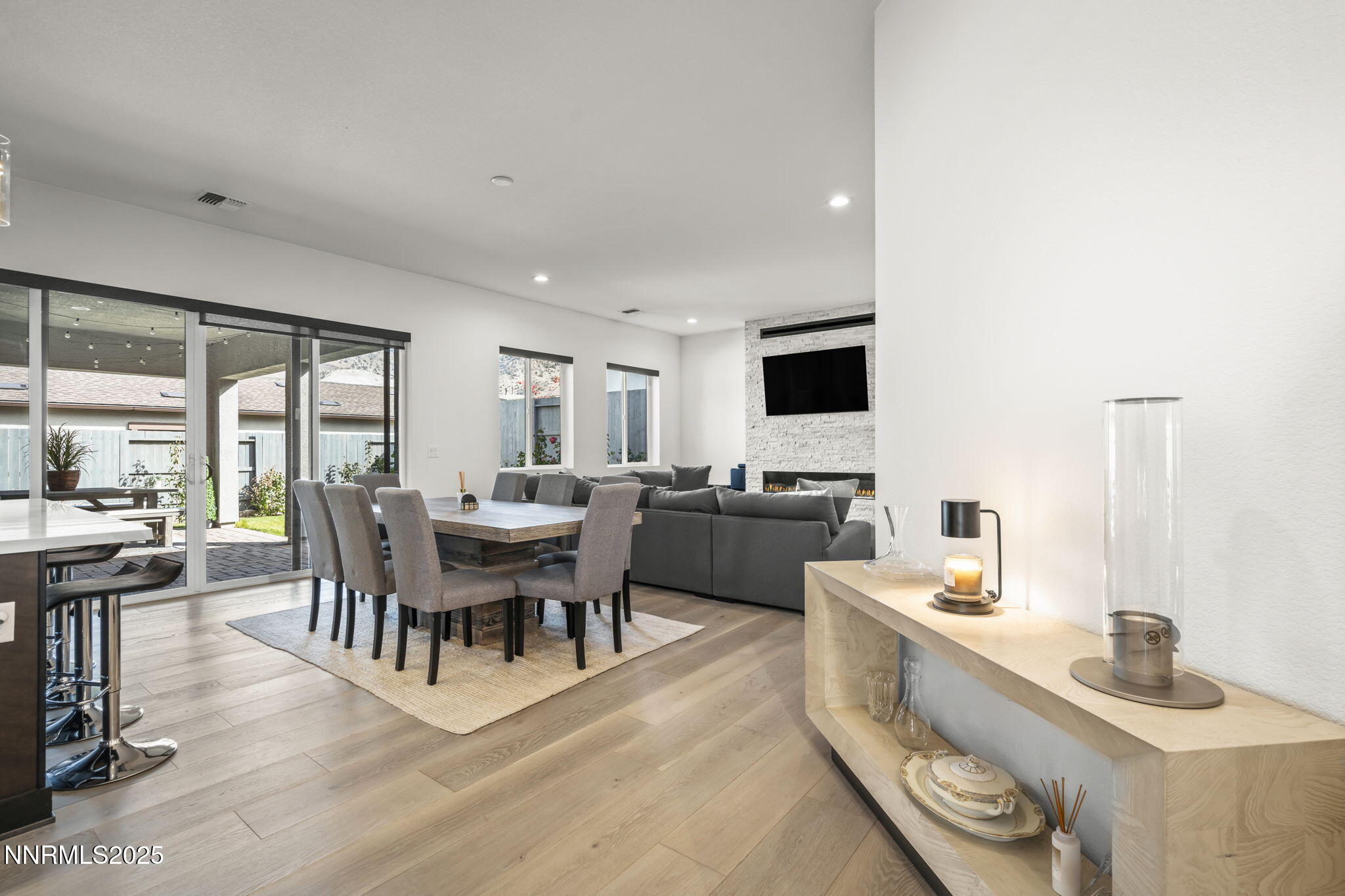 12514 Woods Clover Street Reno, NV 89521 - Photo 9 of 23 a view of a dining room with furniture and wooden floor
