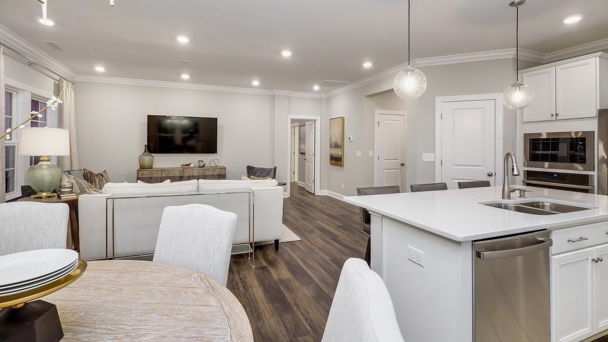 4030 Frontrunner Drive, Unit 46 Durham, NC 27703 - Photo 11 of 25 a room with a sink a flat screen tv and couches