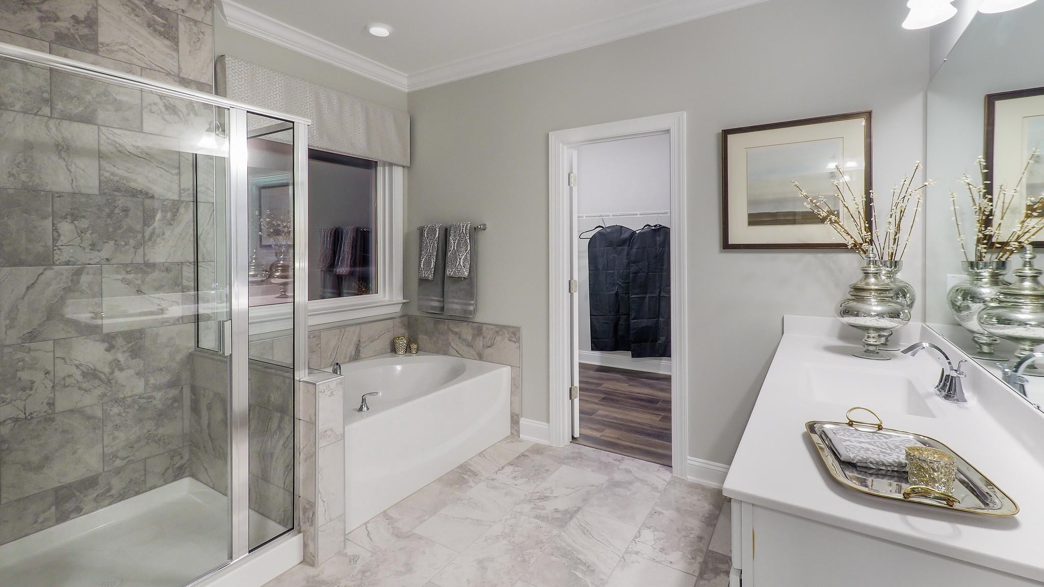 4030 Frontrunner Drive, Unit 46 Durham, NC 27703 - Photo 17 of 25 a bathroom with a tub sink and mirror