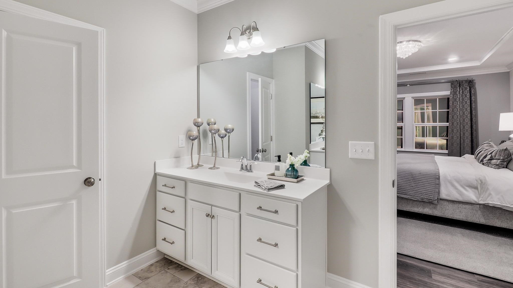 4030 Frontrunner Drive, Unit 46 Durham, NC 27703 - Photo 18 of 25 a en suite bathroom with a double vanity sink a mirror and a shower