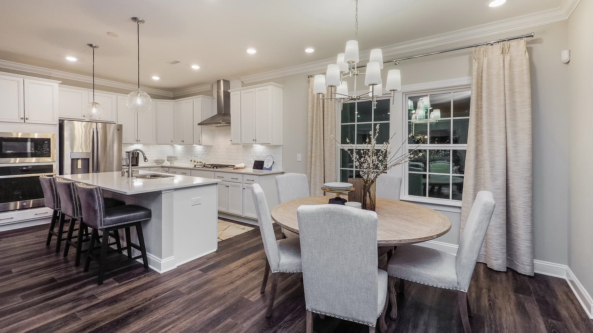 4030 Frontrunner Drive, Unit 46 Durham, NC 27703 - Photo 10 of 25 a dining room filled chandelier and wooden floor