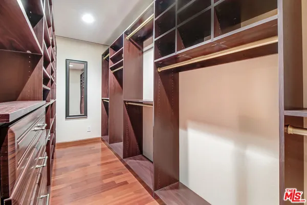 a bedroom with bed and wooden floor