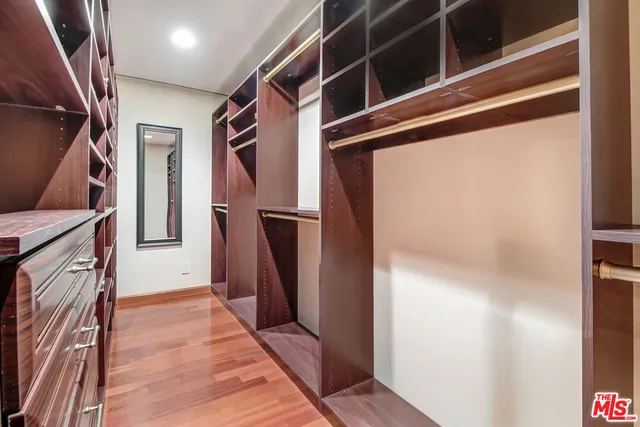a bedroom with bed and wooden floor